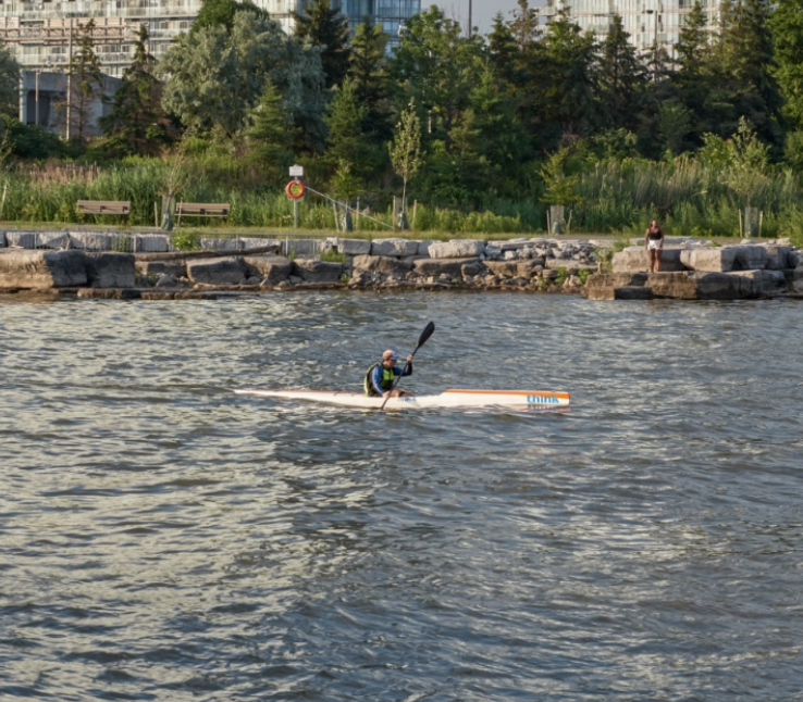 Kayaker paddling through Lake Ontario
